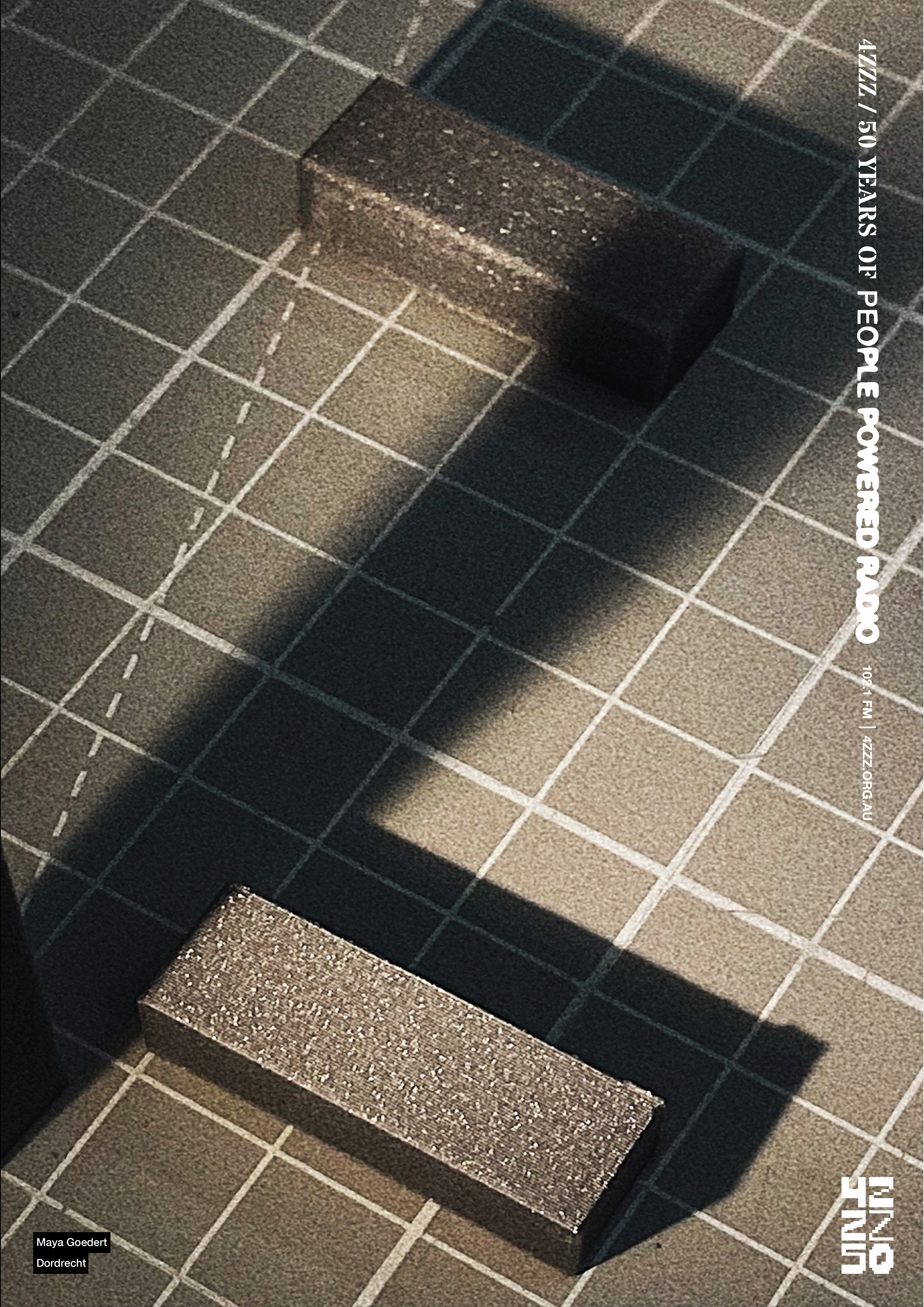 two gunmetal grey blocks sit on a grid marked cutting mat. a bright angled light casts shadows in the shape of a Z.