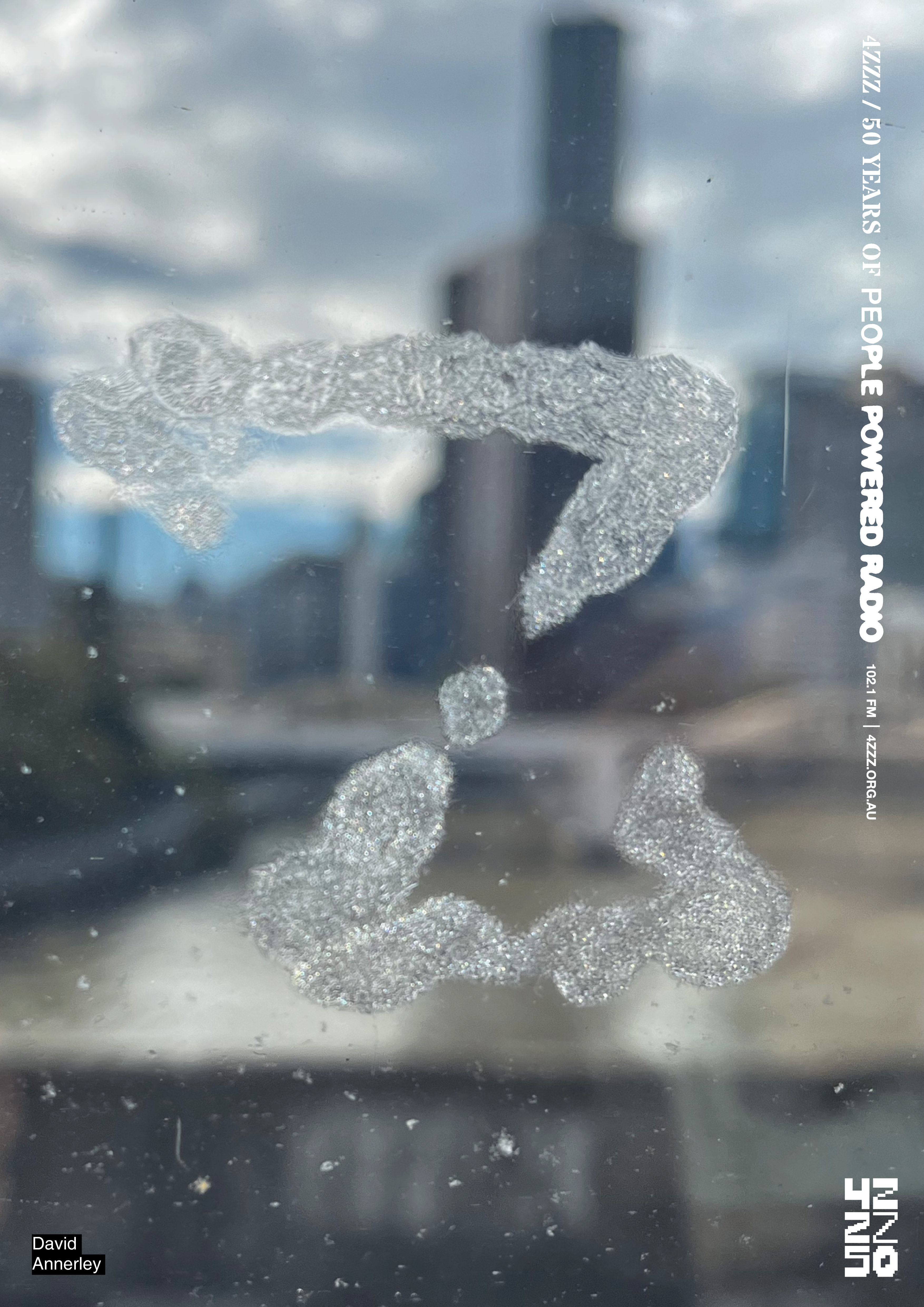 A photograph of a train window, the window is damaged in a way that resembles a Z, the Brisbane River is visible through the window. 