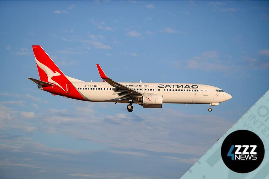 A Quantas plane flying over clouds