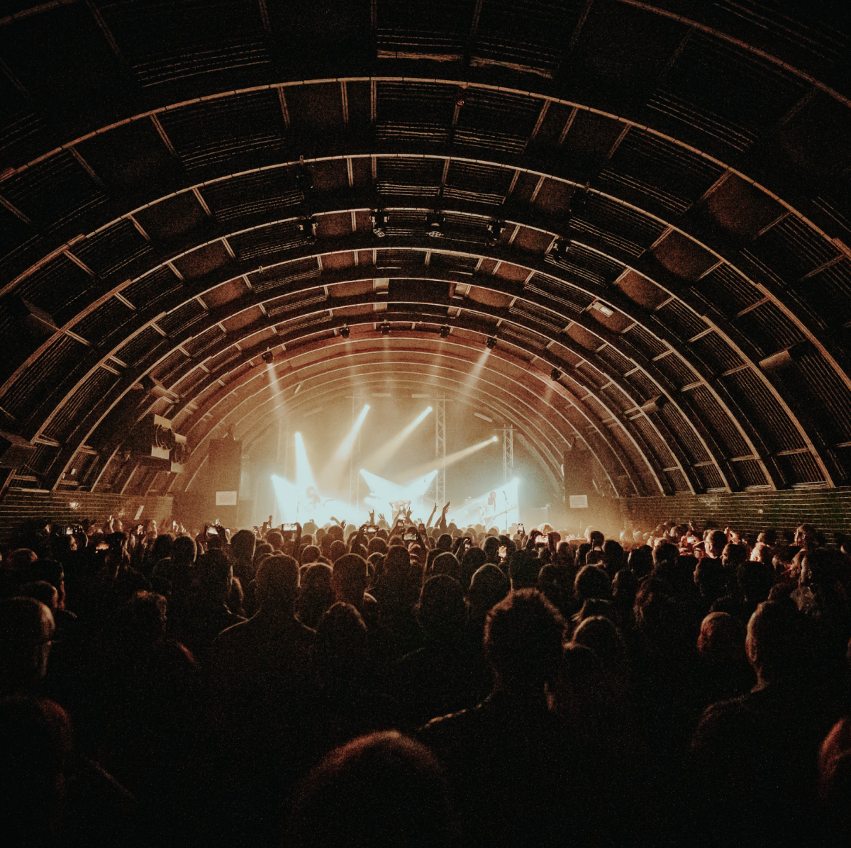 The Triffid inside stage featuring a sold out show and massive crowd with yellow and white lighting