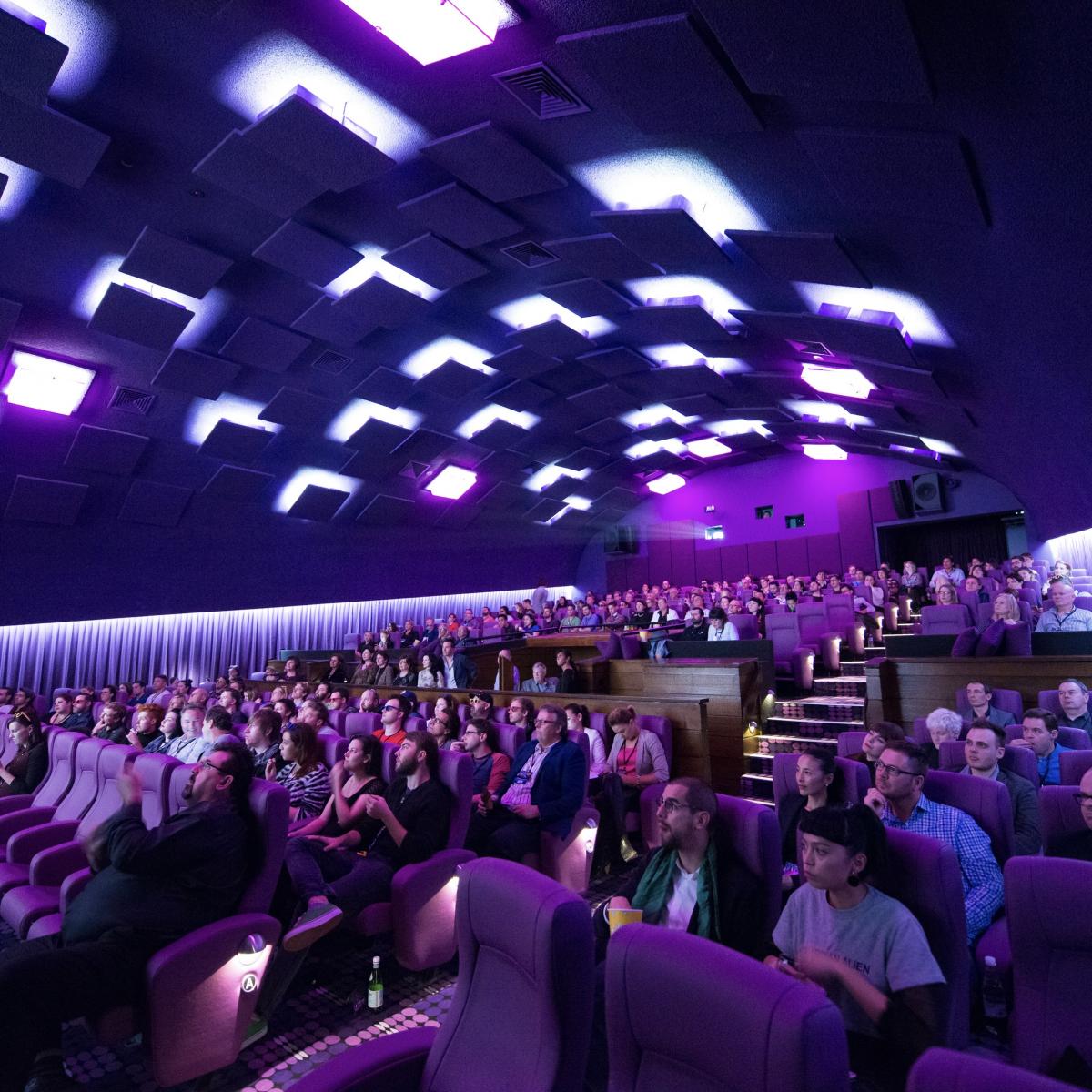 Photo of inside the main cinemas at Five Star Cinemas New Farm. There is lots of people in seats looking towards where the screen would be.