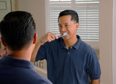 Image of man brushing his teeth 