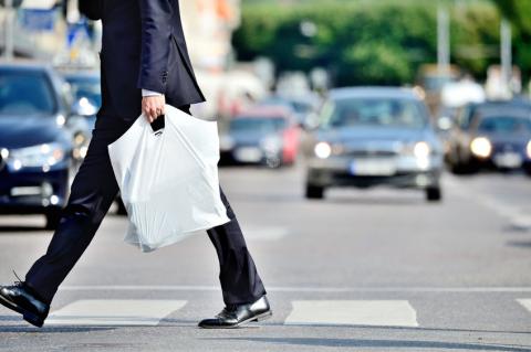 Image of person in suit crossing road