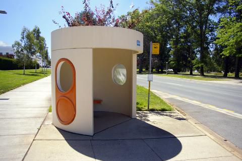 Image of a white and orange Canberran bus stop.