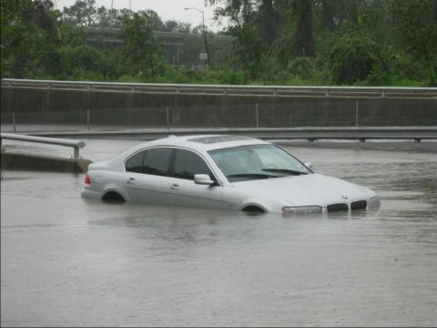car sinking in floodwaters
