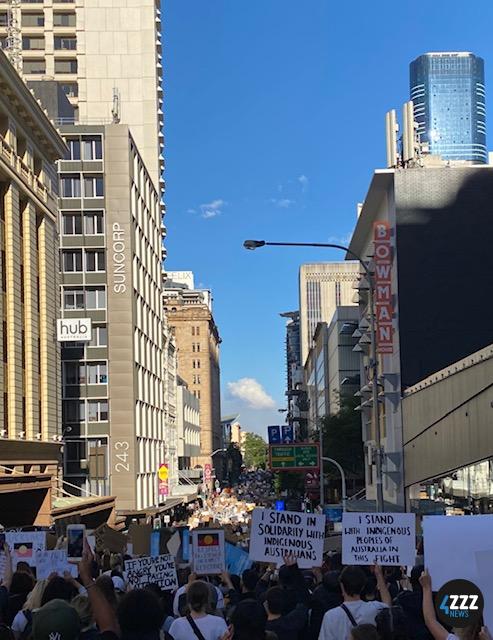 BLM Rally - Protesters marching down Edward Street [4ZZZ/Isabella Jeffrey]