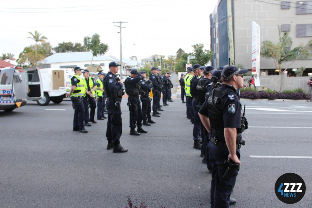 Rows of officers prepare to clear Main St at 5pm, when the authorisation for the Main St. road closure expires. [4ZZZ/Lillian Rangiah]