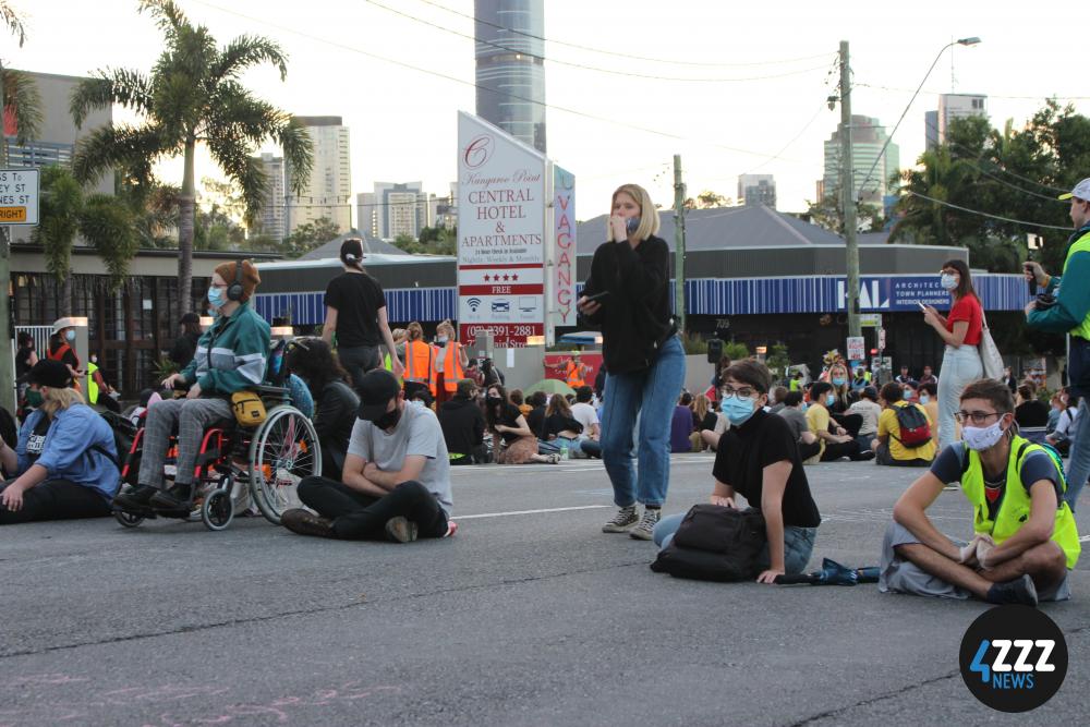 The front line of protesters refusing to move off the road, including Greens candidate for South Brisbane, Amy McMahon [4ZZZ/Lillian Rangiah]