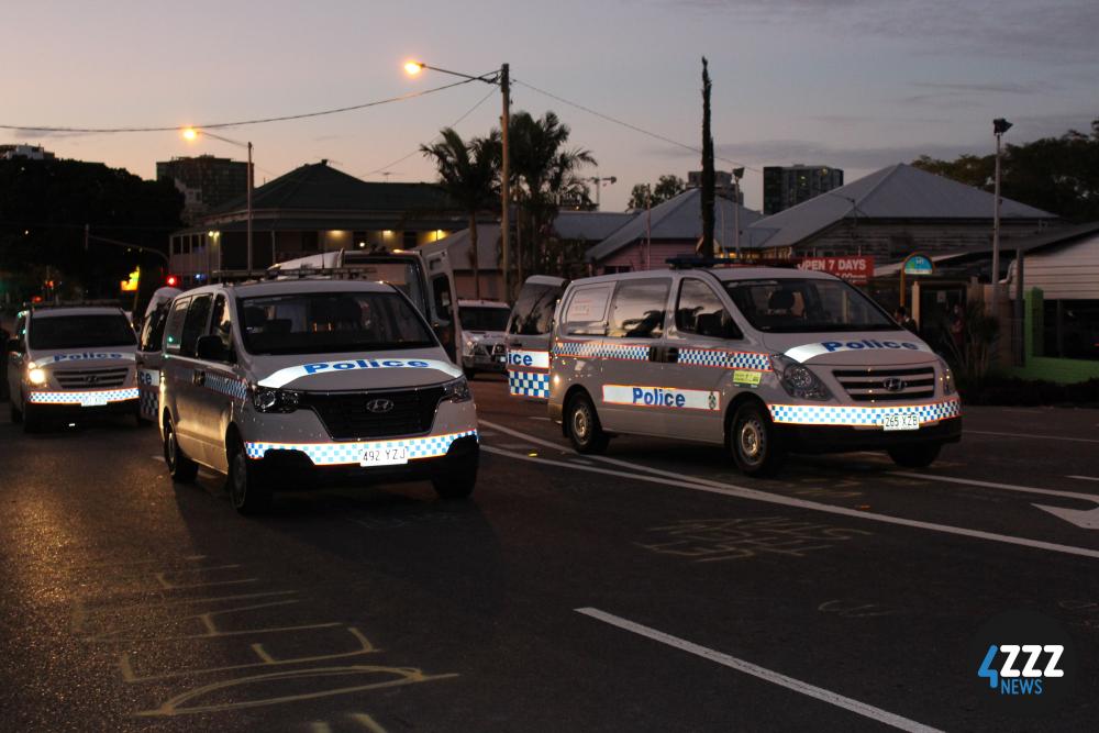 6 police vans on Main St after protesters have been cleared from the road. [4ZZZ/Lillian Rangiah]