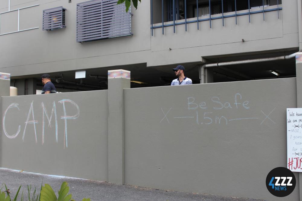 Serco private security keep an eye on the protest from inside the detention centre. [4ZZZ/Lillian Rangiah]