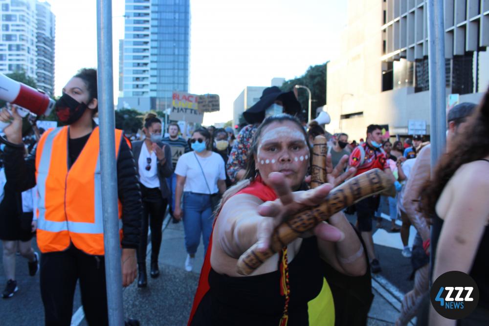 BLM Rally - Protester in traditional indegenous attire [4ZZZ/Lillian Rangiah]