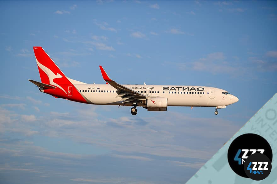 A Quantas plane flying over clouds